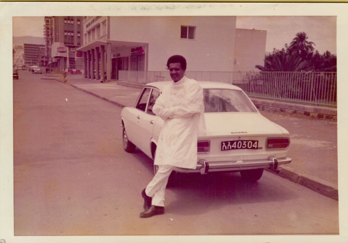 Young Amha leaning on a car in Addis Ababa, 1970s