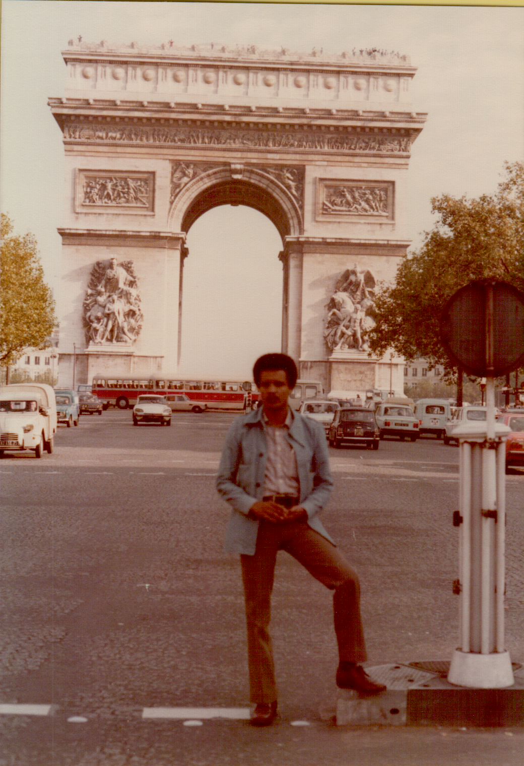 Amha leaning casually at the Arc de Triomphe, Paris